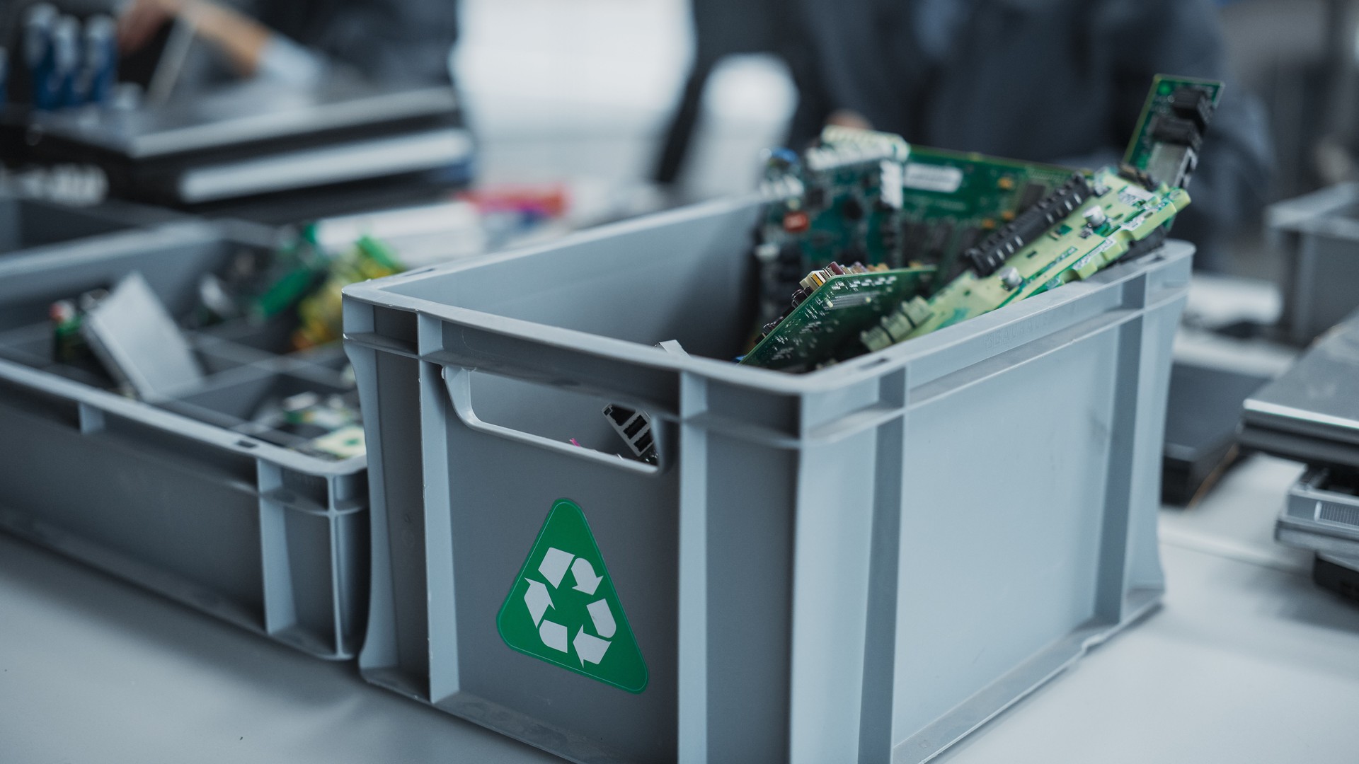 Close Up Shot Of Boxes With Computer Parts Sorted For Recycling At Sustainable Electronics Factory. Motherboards And Microchips Are Collected And Prepared For Reuse in Technological Devices.